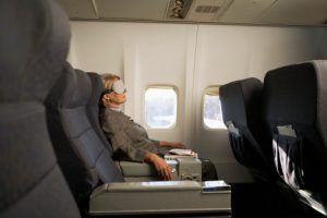 Business traveller getting to sleep on a plane